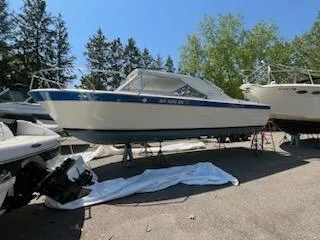 Slide: The Image of 1968 Chris-Craft COMMANDER 27 boat on display, surrounded by trees and other boats. - 20