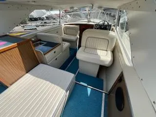Slide: The Image of 1968 Chris-Craft COMMANDER 27 interior with white seating and blue carpet. - 21