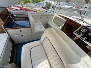 Slide: The Image of 1968 Chris-Craft COMMANDER 27 interior with white seating and classic dashboard. - 22