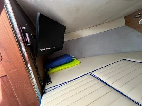 Slide: The Image of 1968 Chris-Craft COMMANDER 27 cabin interior with TV and cushions. - 26