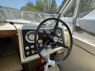 Slide: The Image of 1968 Chris-Craft COMMANDER 27 boat dashboard with steering wheel and gauges. - 27