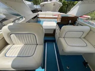 Slide: The Image of 1968 Chris-Craft COMMANDER 27 interior with white seating and blue flooring. - 28