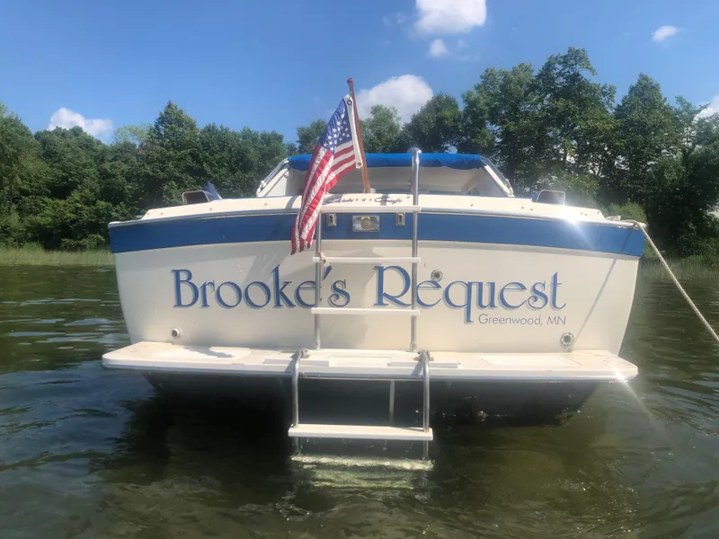 Slide: The Image of 1968 Chris-Craft COMMANDER 27 boat named "Brooke's Request" on water, American flag, sunny day. - 3