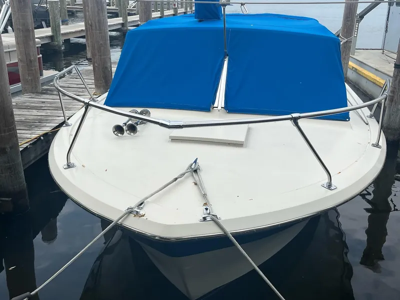 Slide: The Image of 1968 Chris-Craft COMMANDER 27 boat with blue cover docked at marina. - 6