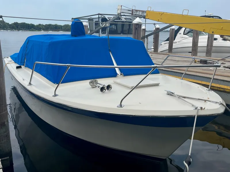 Slide: The Image of 1968 Chris-Craft COMMANDER 27 boat with blue cover docked at marina. - 7