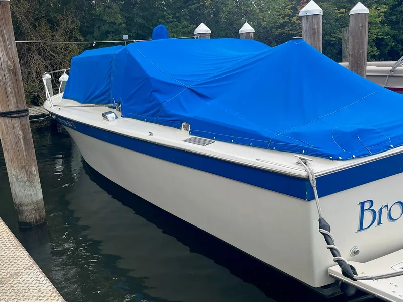 Slide: The Image of 1968 Chris-Craft COMMANDER 27 boat with blue cover docked at marina. - 8