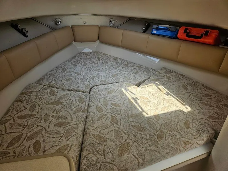 Slide: The Image of 2005 Robalo R265 Walkaround cabin interior with patterned cushions and storage compartments. - 10