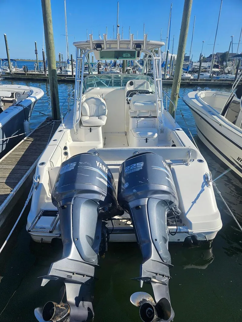 Slide: The Image of 2005 Robalo R265 Walkaround boat with dual Yamaha engines docked at marina. - 3