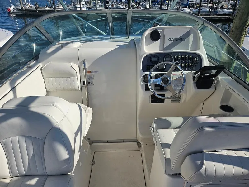 Slide: The Image of 2005 Robalo R265 Walkaround boat cockpit with Garmin navigation system and white seating. - 4