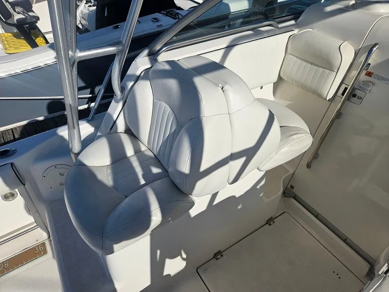 Slide: The Image of 2005 Robalo R265 Walkaround boat interior with white cushioned seating. - 5