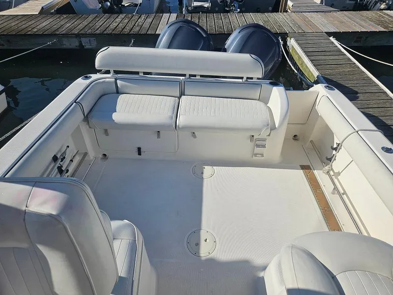 Slide: The Image of 2005 Robalo R265 Walkaround boat interior with seating and twin outboard motors. - 6