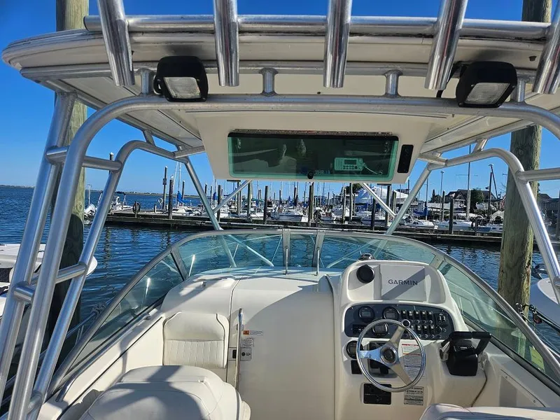 Slide: The Image of 2005 Robalo R265 Walkaround boat interior with steering wheel, docked at marina. - 7