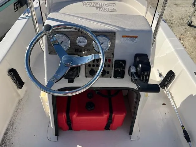 Slide: The Image of 2025 Carolina Skiff E16 JVX CC boat console with steering wheel and controls. - 5