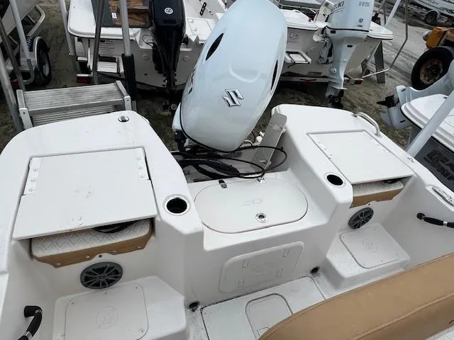 Slide: The Image of 2025 Carolina Skiff 17 LS boat with Suzuki outboard motor, featuring storage compartments and speakers. - 2