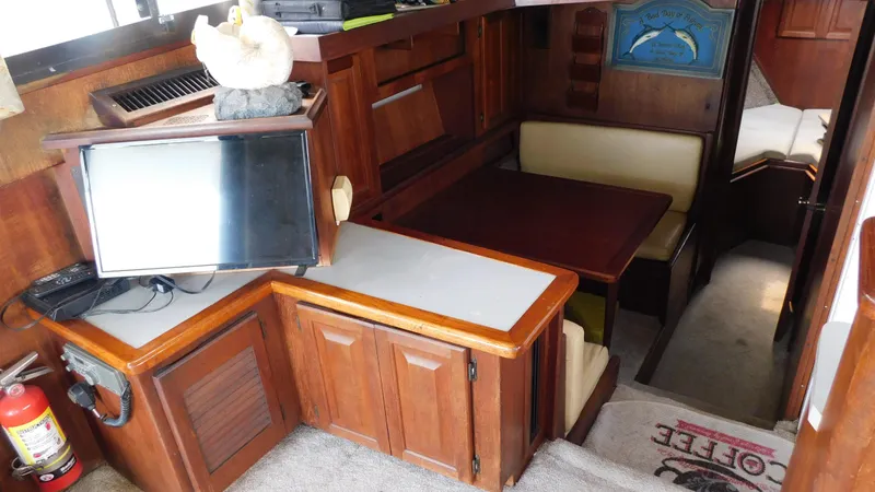 Slide: The Image of Interior of 1986 Viking 35 Sportfish boat with wood cabinetry and seating area. - 11