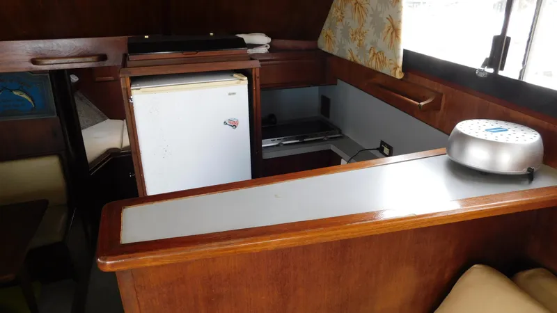 Slide: The Image of Interior of 1986 Viking 35 Sportfish boat with kitchenette and seating area. - 12