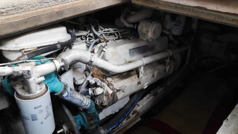 Slide: The Image of Engine compartment of a 1986 Viking 35 Sportfish boat, showcasing mechanical components. - 18