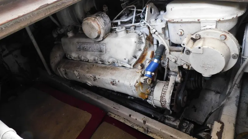 Slide: The Image of Engine compartment of a 1986 Viking 35 Sportfish boat, showcasing mechanical components. - 19