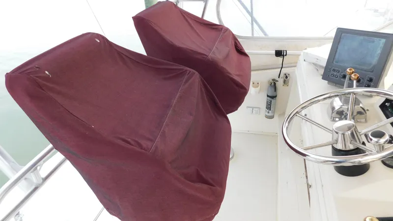 Slide: The Image of 1986 Viking 35 Sportfish helm with covered seats and steering wheel. - 25