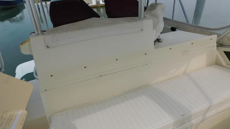 Slide: The Image of 1986 Viking 35 Sportfish boat interior with white seating and helm area. - 28
