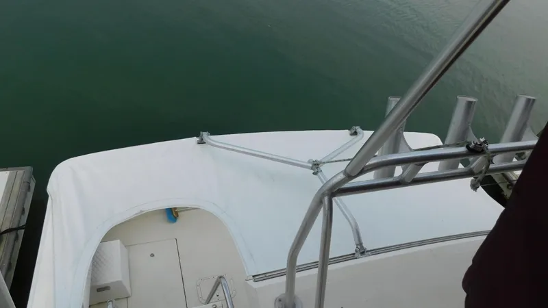 Slide: The Image of 1986 Viking 35 Sportfish boat deck with railing, docked on calm water. - 30