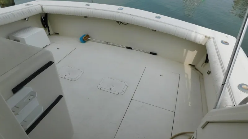 Slide: The Image of 1986 Viking 35 Sportfish boat deck with white seating and storage compartments. - 31