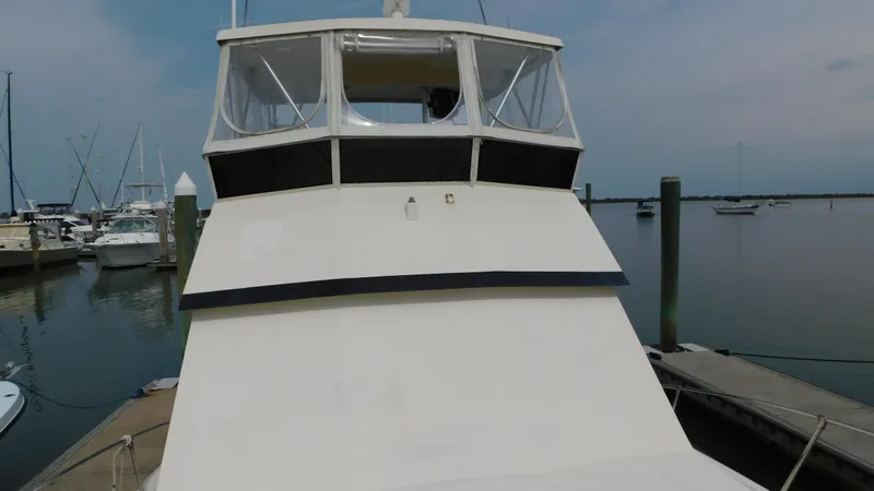 Slide: The Image of 1986 Viking 35 Sportfish boat docked at marina, clear sky, calm water. - 33