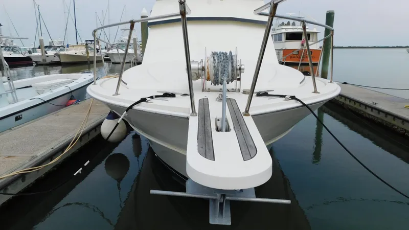 Slide: The Image of 1986 Viking 35 Sportfish boat docked at marina, front view. - 36