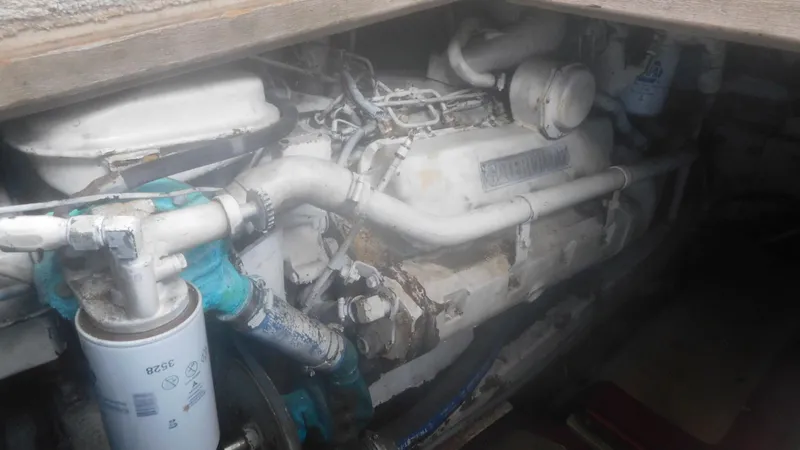Slide: The Image of Engine compartment of a 1986 Viking 35 Sportfish boat, showing detailed mechanical components. - 41