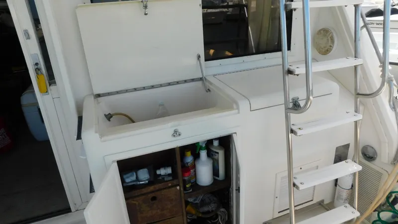 Slide: The Image of 1986 Viking 35 Sportfish boat interior with storage compartments and ladder. - 44