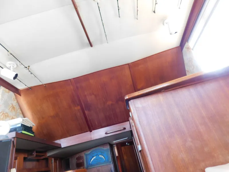 Slide: The Image of Interior view of 1986 Viking 35 Sportfish boat with wooden paneling and fishing rods. - 45