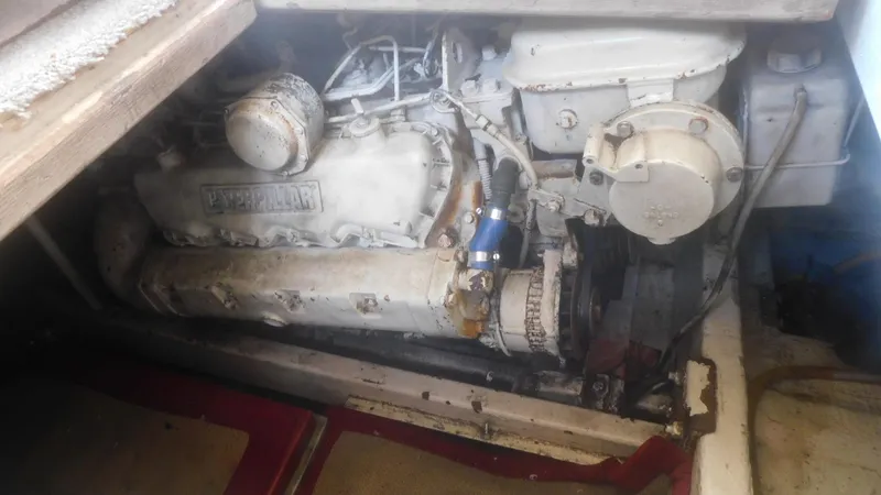 Slide: The Image of Engine compartment of a 1986 Viking 35 Sportfish boat, featuring a Caterpillar engine. - 46