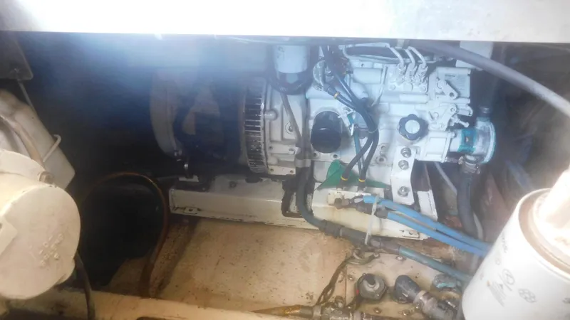 Slide: The Image of Engine compartment of a 1986 Viking 35 Sportfish boat, showing mechanical components and wiring. - 47
