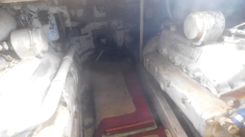 Slide: The Image of Engine room of 1986 Viking 35 Sportfish boat, featuring dual engines and mechanical components. - 48