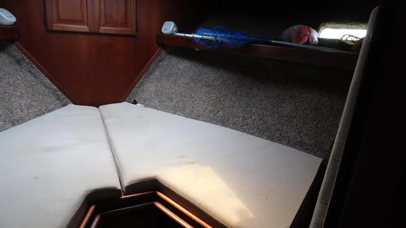Slide: The Image of 1986 Viking 35 Sportfish cabin interior with V-berth and storage shelves. - 5