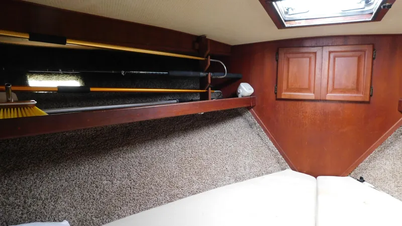 Slide: The Image of Interior cabin of a 1986 Viking 35 Sportfish boat with wood paneling and storage shelves. - 6