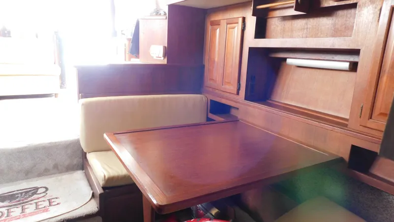 Slide: The Image of Interior of 1986 Viking 35 Sportfish with wooden table and built-in storage. - 7