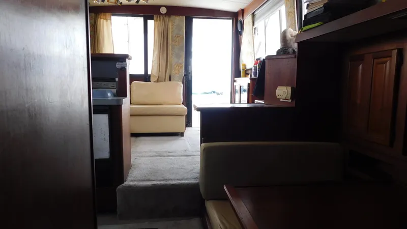 Slide: The Image of Interior of 1986 Viking 35 Sportfish yacht with beige seating and wooden cabinetry. - 8