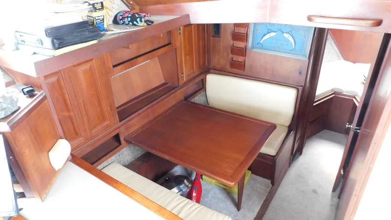 Slide: The Image of 1986 Viking 35 Sportfish interior with wooden cabinetry and cozy dining area. - 9
