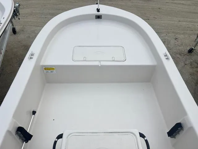 Slide: The Image of 2025 Carolina Skiff 20 JVX CC boat interior, featuring spacious white deck and storage compartment. - 6