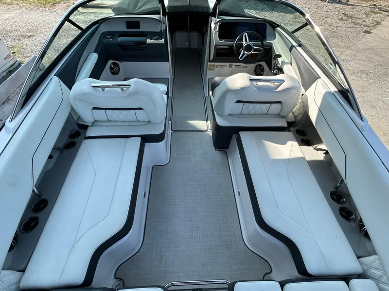 Slide: The Image of 2021 Regal LS4 boat interior with white seating and modern dashboard. - 15
