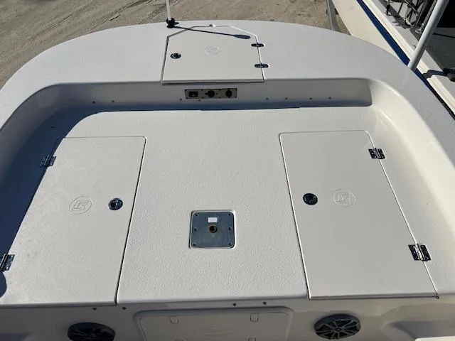 Slide: The Image of 2025 Carolina Skiff 23 LS boat deck with storage compartments and speakers. - 11