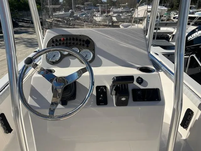 Slide: The Image of 2025 Carolina Skiff 23 LS boat console with steering wheel and controls. - 6