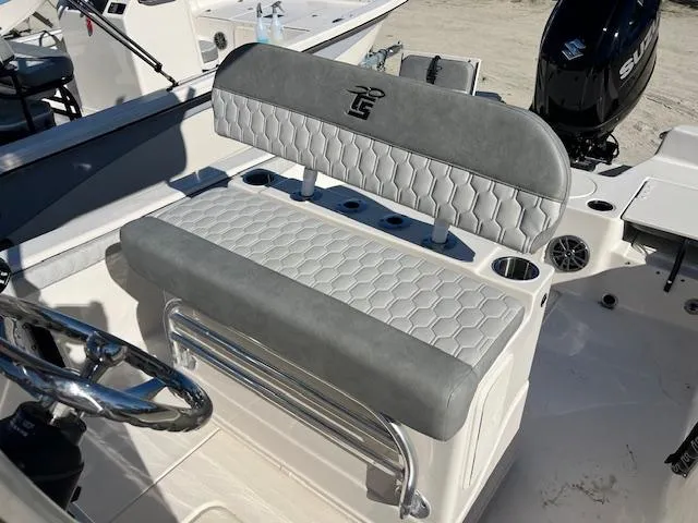Slide: The Image of 2025 Carolina Skiff 23 LS boat seat with gray and white upholstery, featuring cup holders. - 7