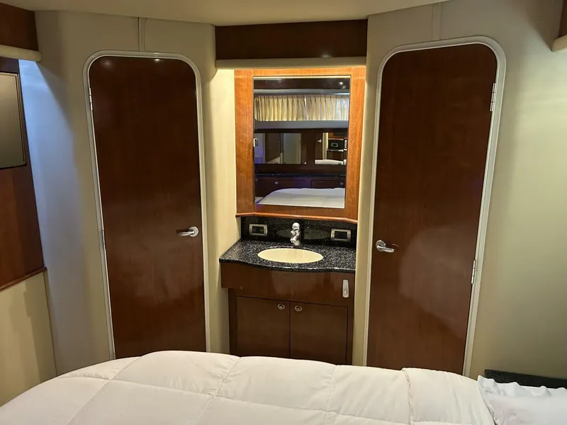 Slide: The Image of Interior of 2004 Sea Ray 390 Motor Yacht with vanity and wooden doors. - 25