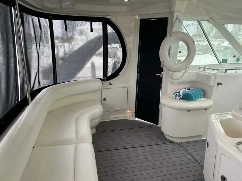 Slide: The Image of 2004 Sea Ray 390 Motor Yacht interior with white seating and life preserver. - 7