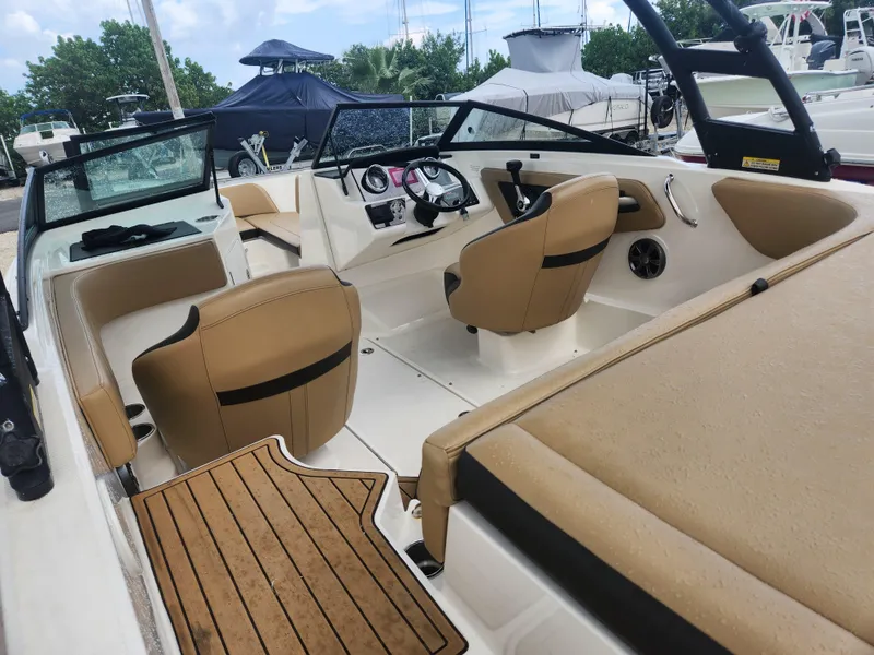 Slide: The Image of 2020 Sea Ray SPX 190 boat interior with tan seating and modern dashboard. - 10