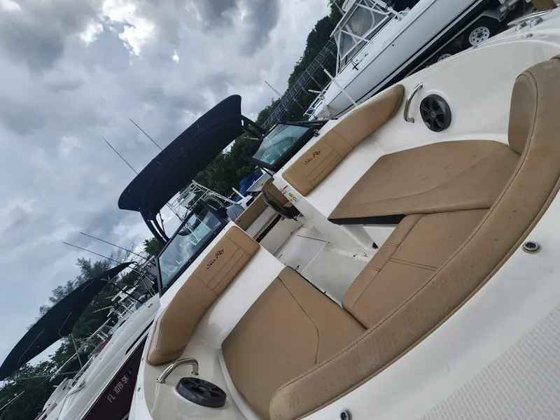 Slide: The Image of 2020 Sea Ray SPX 190 boat with tan seating, docked under cloudy skies. - 13
