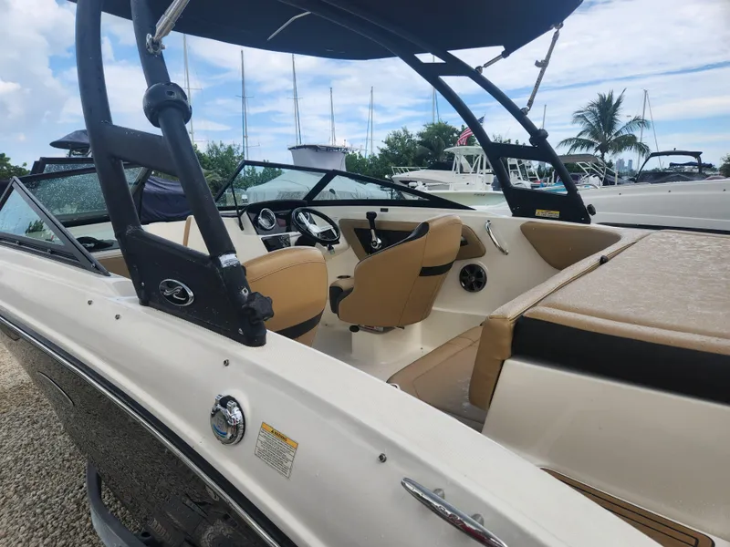 Slide: The Image of 2020 Sea Ray SPX 190 boat interior with tan seating and steering wheel. - 14