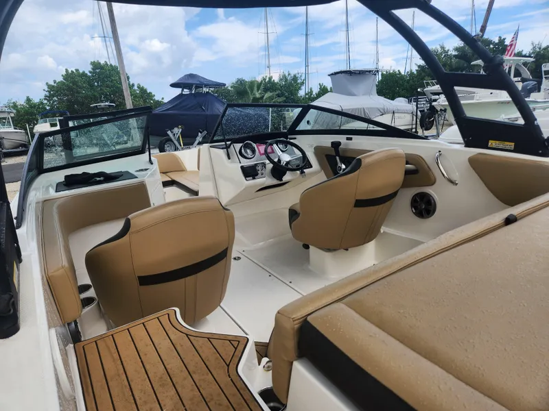 Slide: The Image of 2020 Sea Ray SPX 190 boat interior with tan seats and steering wheel. - 15